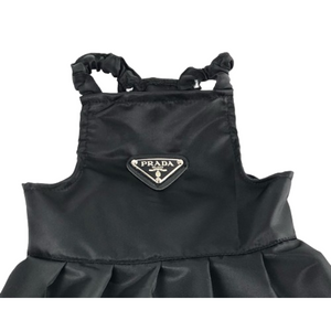 Close-up of black nylon dog dress showing Prada triangle logo detail and construction