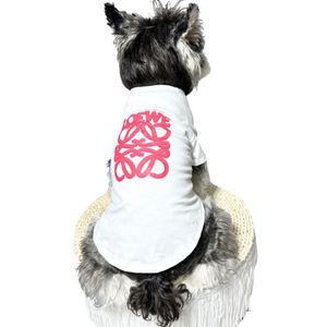 Small dog wearing white tee with pink Woof-White logo script on back
