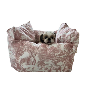 Small dog sitting in pink Dogior oblique print plush travel bed