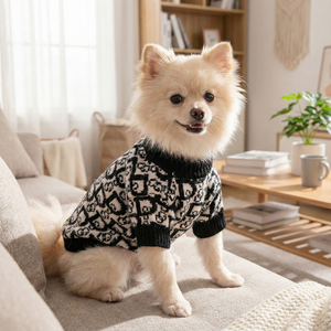 Pomeranian wearing black cream Dogior monogram sweater in living room