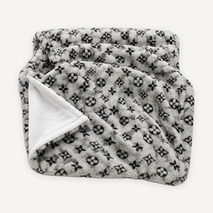 Grey monogram plush dog blanket inspired by Louis Vuitton, folded to show the white reverse