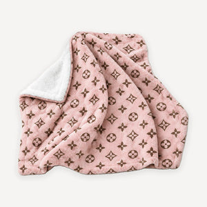 Pink monogram plush dog blanket inspired by Louis Vuitton, folded to show the white reverse