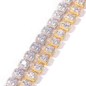 Close-up detail of gold and silver tennis chains with clustered cubic zirconia stones