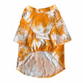 Orange and white tie dye dog tee with Drew smiley face graphics on white background