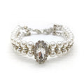 White faux pearl dog necklace with oval rhinestone centerpiece on white background