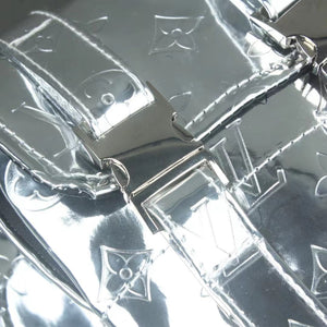 Close-up detail of clear dog backpack showing V monogram pattern and metal buckles