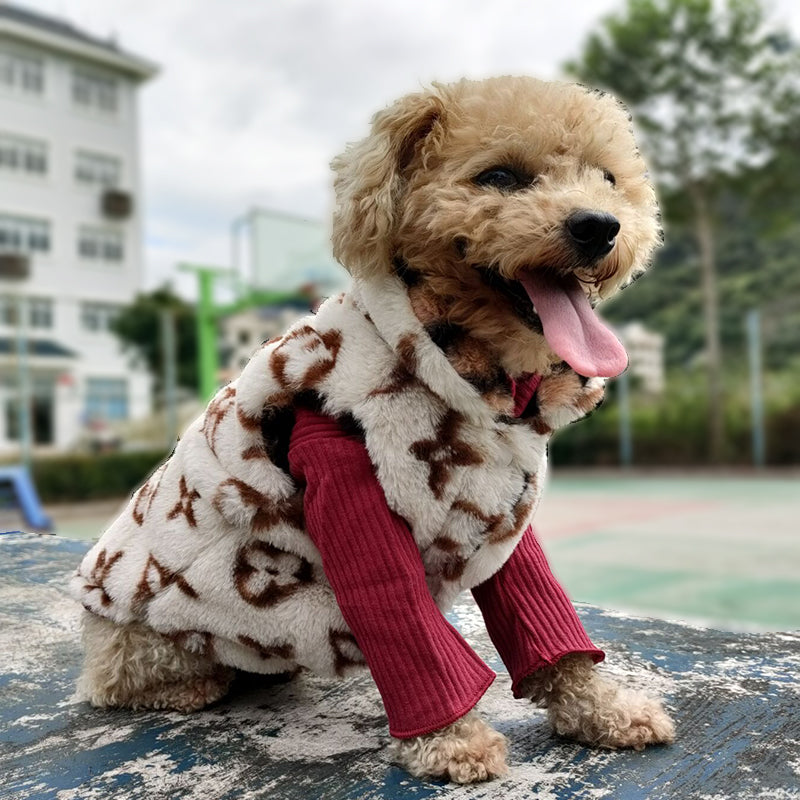 Small dog wearing cream faux fur vest with V monogram pattern outdoors