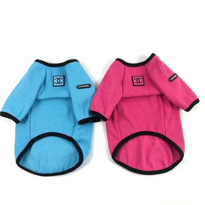 Blue and pink dog sweatshirts side by side showing Chanel logo patches and waffle texture