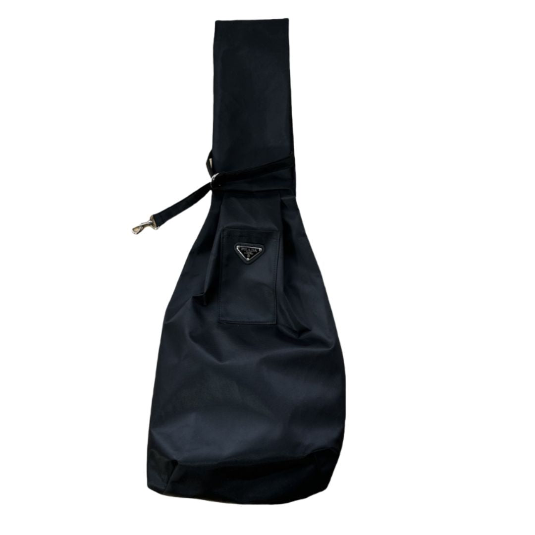 Black nylon dog sling carrier Prada style with triangle logo badge and adjustable strap