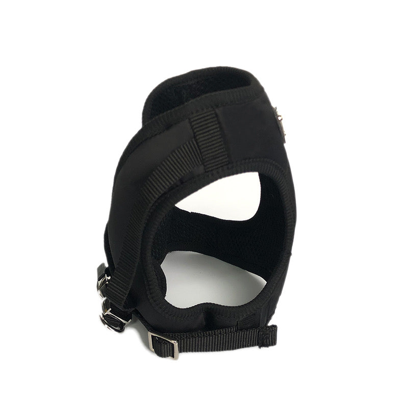 Black dog harness interior view showing padded chest area and secure buckle system