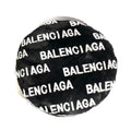 Black faux fur dog bed with white Balenciaga logo print all over surface