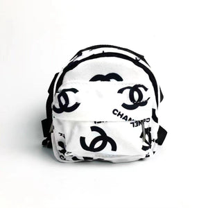 White canvas dog backpack with black Chanel inspired logos and adjustable straps