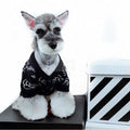 Black knit dog sweater with white Chanel logo and camellia flower print inspired by Chanel