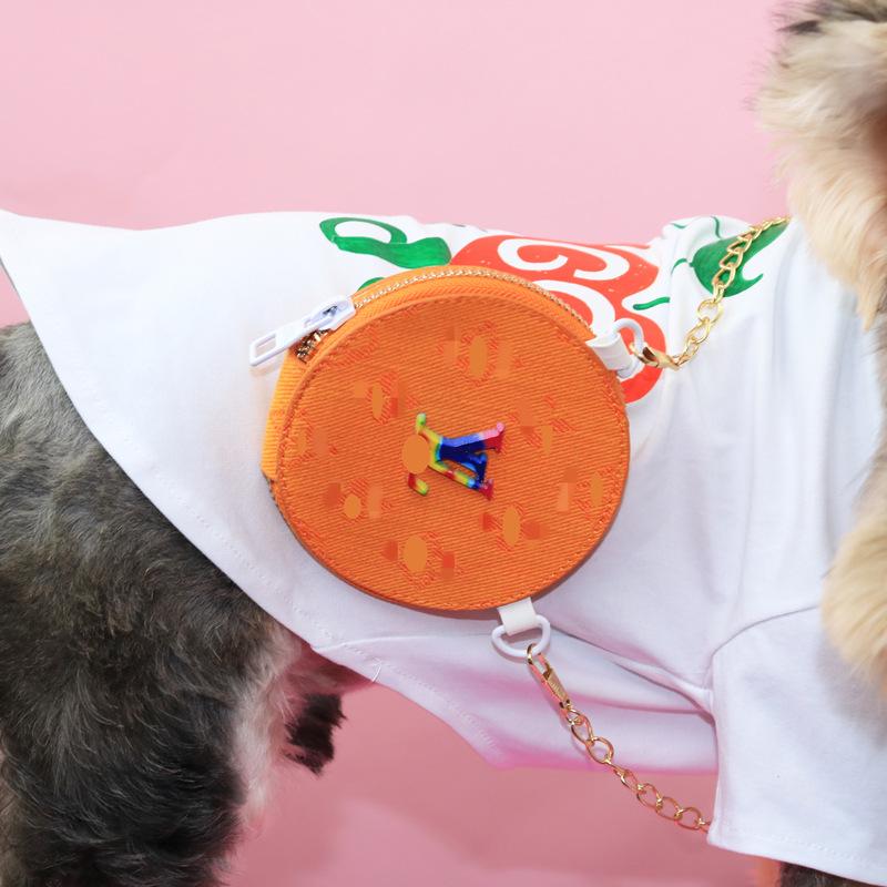 Close up orange monogram crossbody bag with colorful V pattern and chain strap on dog