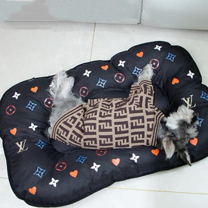 Luxury dog bed with LV style monogram print featuring hearts stars and geometric motifs in multiple colors