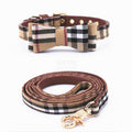 Tan plaid dog collar with bow detail and matching leash inspired by Burberry on white background
