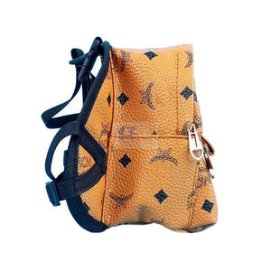 Side view of MCM monogram carrier with adjustable chest and shoulder straps