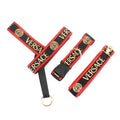 Black and red dog harness set with Versace text and gold medusa logos on white background
